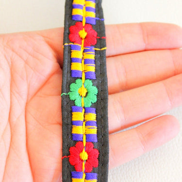 Black Fabric Trim With Green, Blue, Red And Orange Embroidery